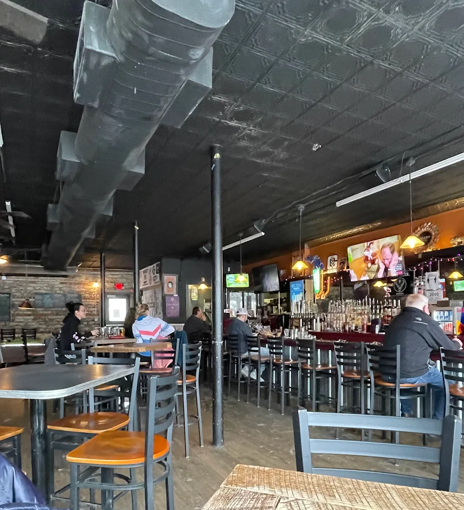 Wide view of Duke's dining room and bar with tin ceiling